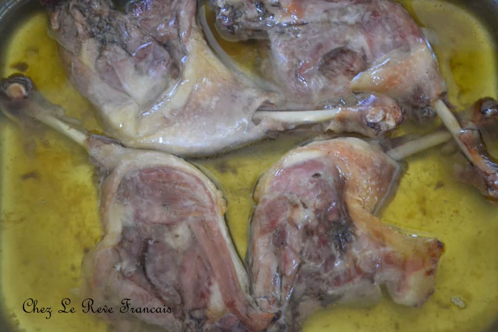 Duck legs, skin side down in melted duck fat.