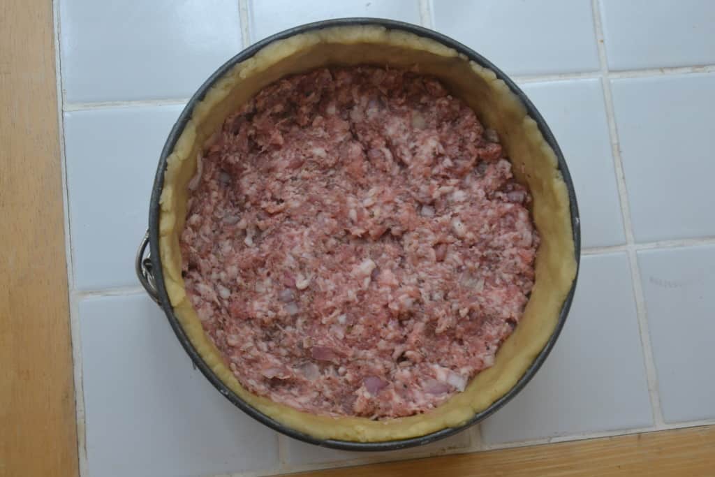 layer of sausage meat added to the tin.