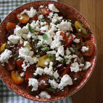 Small tomatoes mixed with fresh oregano, olive oil, red onion and topped with crumbled feta. This makes a simple salad that's big on flavour.