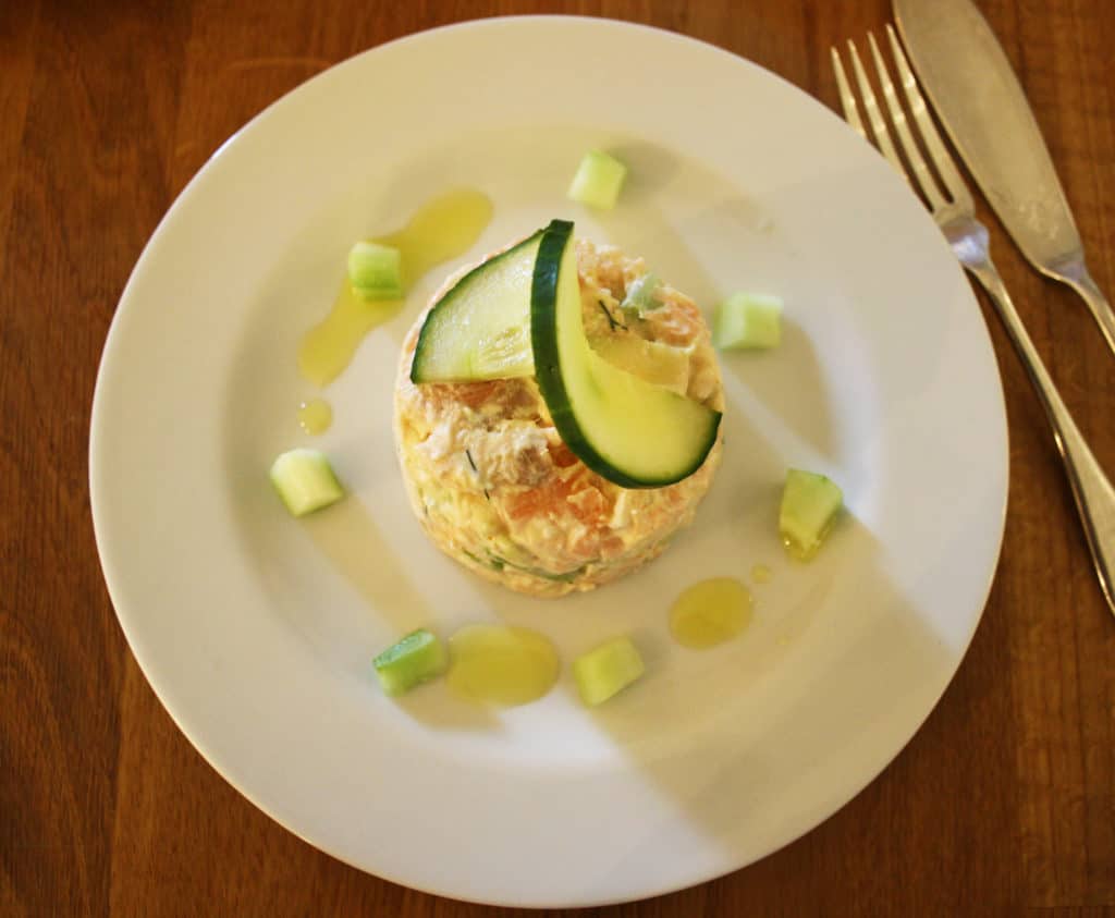 These summer salmon timbales are light and delicate. Smoked and lightly cooked salmon with cucumber and avocado in a creamy dill and lemon dressing.