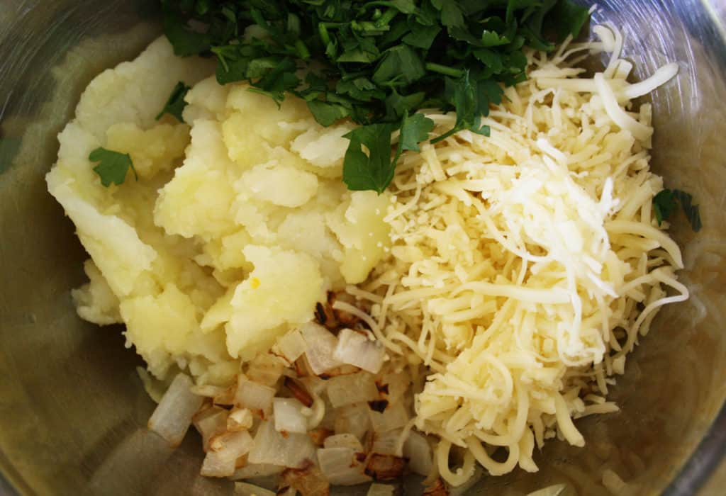 A quick side dish of cheese and onion potato cakes using leftover baked potatoes with parsley or coriander.