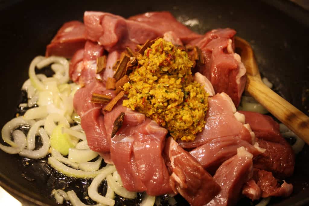 dusk, curry paste and onions in a pan.
