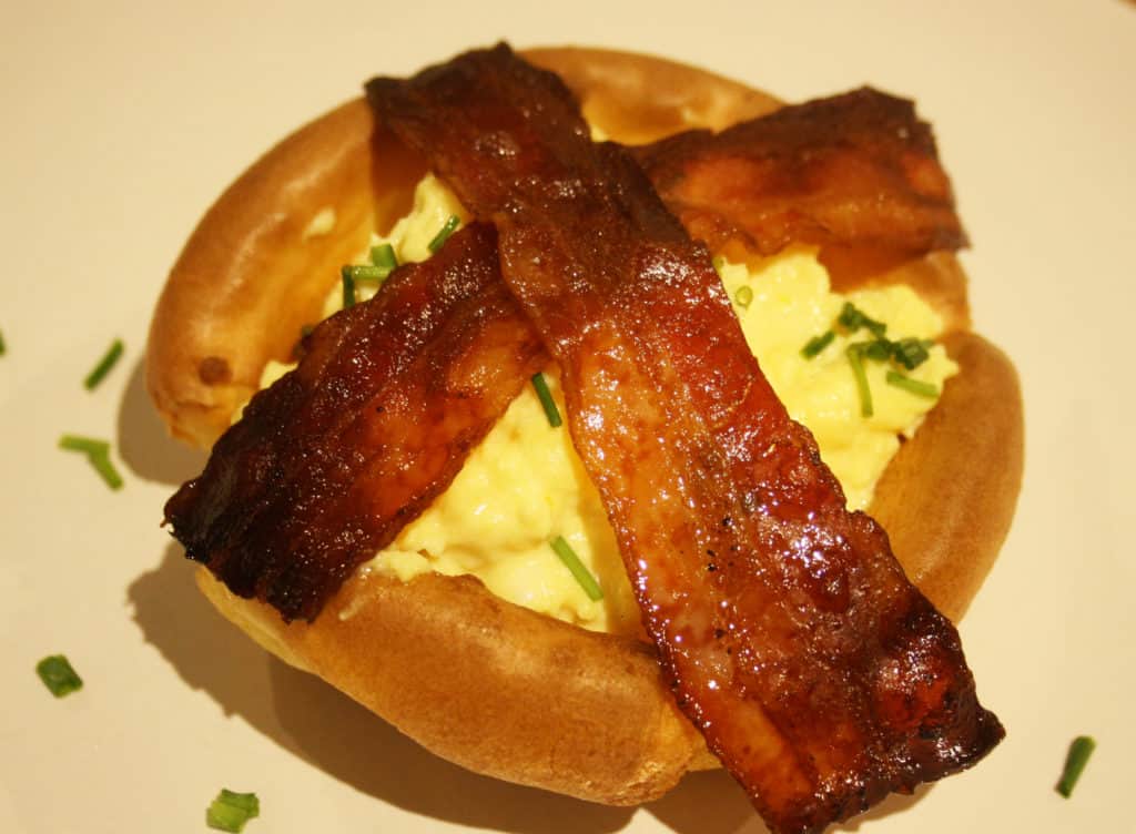 Yorkshire pudding filled with scrambled agg and topped with bacon