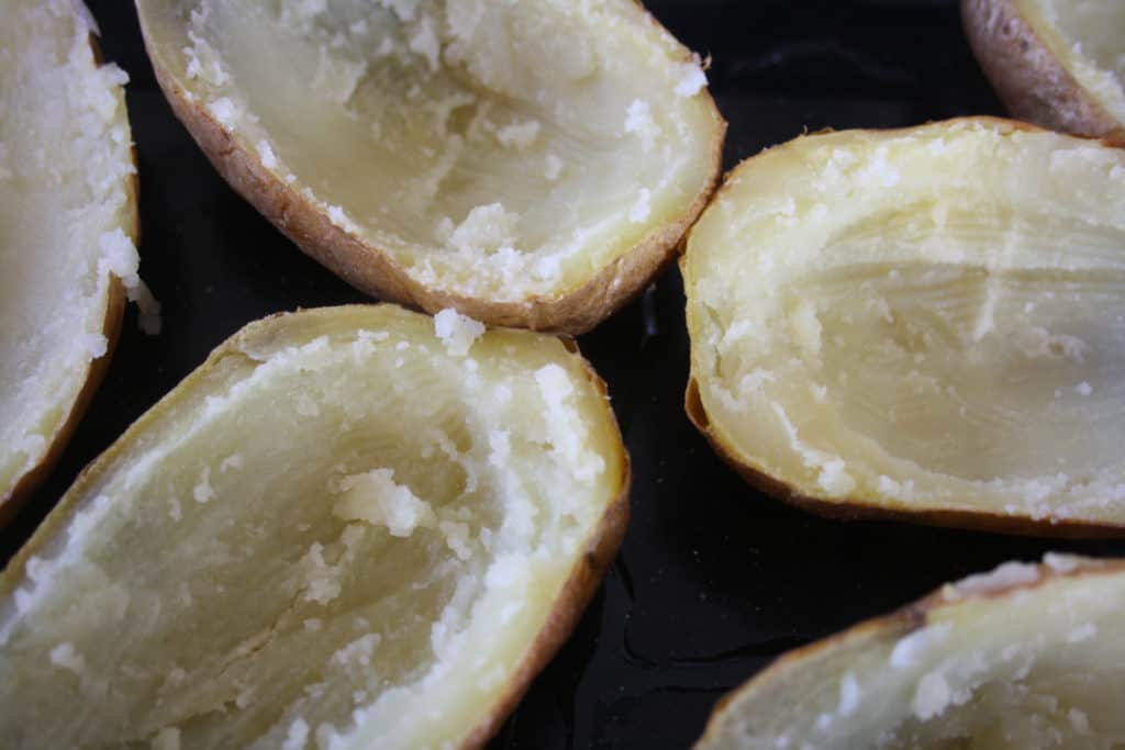 baked potato halves with the middle scraped out.