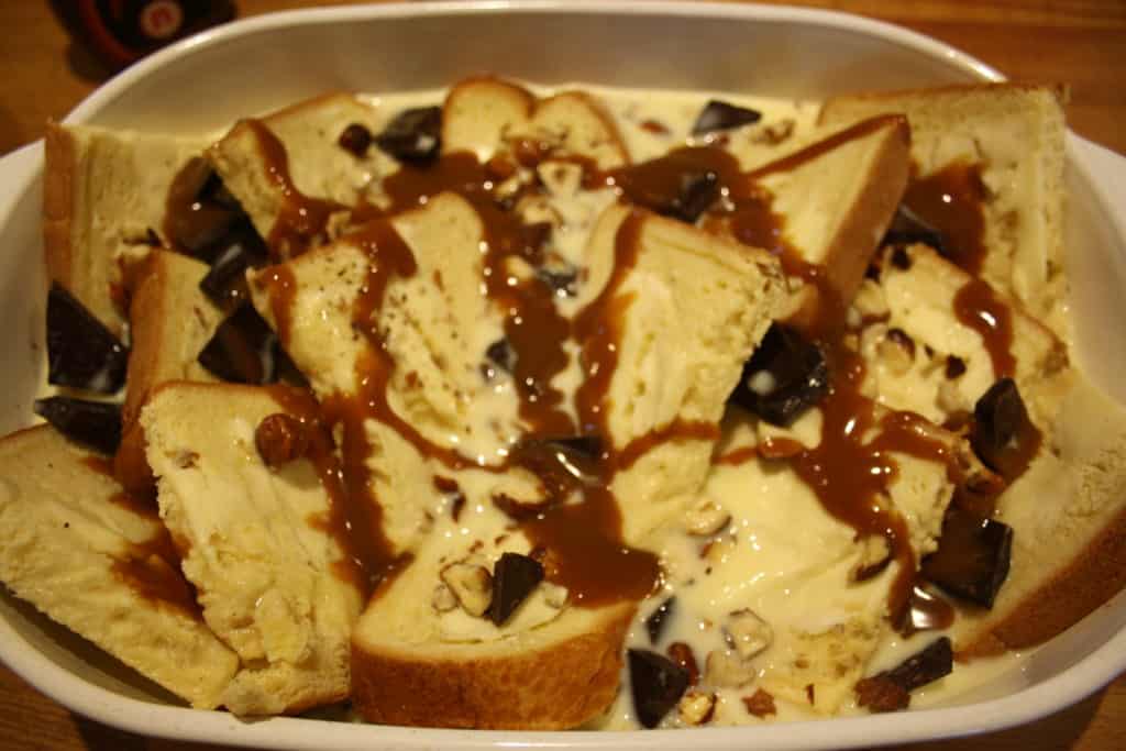 French Bread and Butter Pudding. Sweetened French bread is buttered and strewn with hazelnuts and plain chocolate and then baked in a custard.