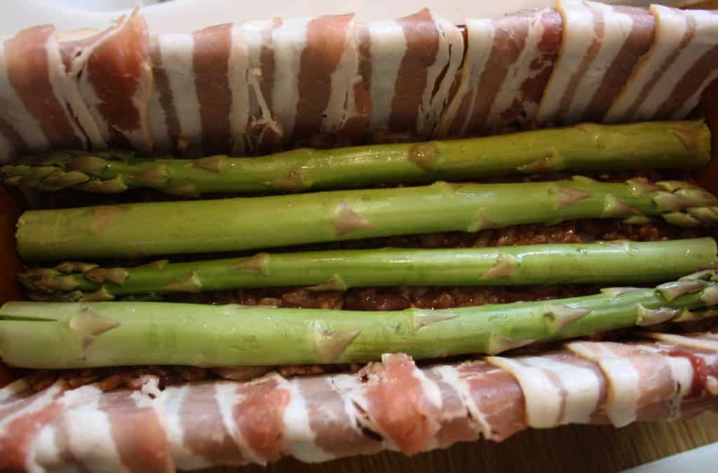 dish showing 4 asparagus spears laying lengthways.