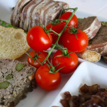 Duck Terrine with Asparagus. Layers of pork mince,liver, duck fillets and asparagus are all wrapped up in streaky bacon for a delicious starter.