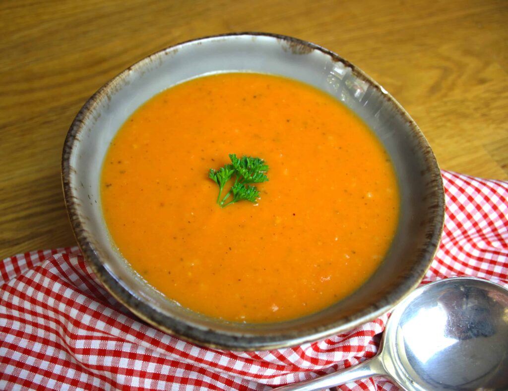 Roasted Tomato Soup with Garlic. Tomatoes and garlic roasted in the oven then combined with stock to make a simple and delicious soup.