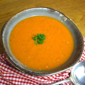 Roasted Tomato Soup with Garlic. Tomatoes and garlic roasted in the oven then combined with stock to make a simple and delicious soup.