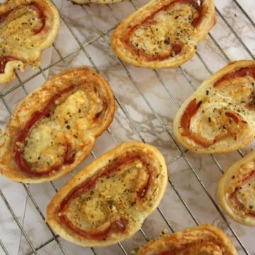 Ham and cheese palmiers on a cooling rackisp French biscuits are simple to do and perfect to serve to guests with drinks.