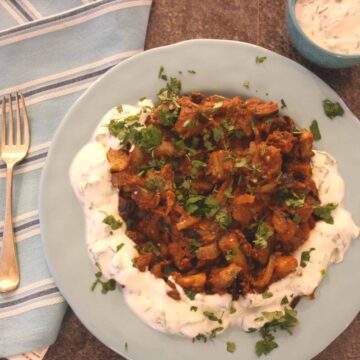 Afghan Aubergine Curry with Minted Yoghurt is an easy main dish or accompaniment. Fried aubergines and onion are placed in a spicy tomato sauce.