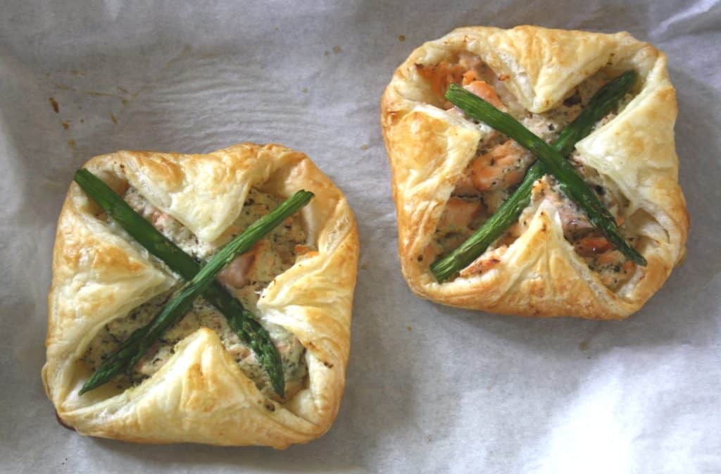 Salmon and Asparagus Puff Pastry Parcels. Poached salmon is mixed with Ricotta cheese, enveloped in puff pastry spread with basil pesto then baked.