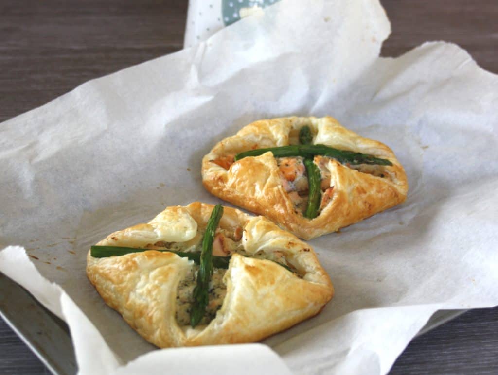 Salmon and Asparagus Puff Pastry Parcels. Poached salmon is mixed with Ricotta cheese, enveloped in puff pastry spread with basil pesto then baked.