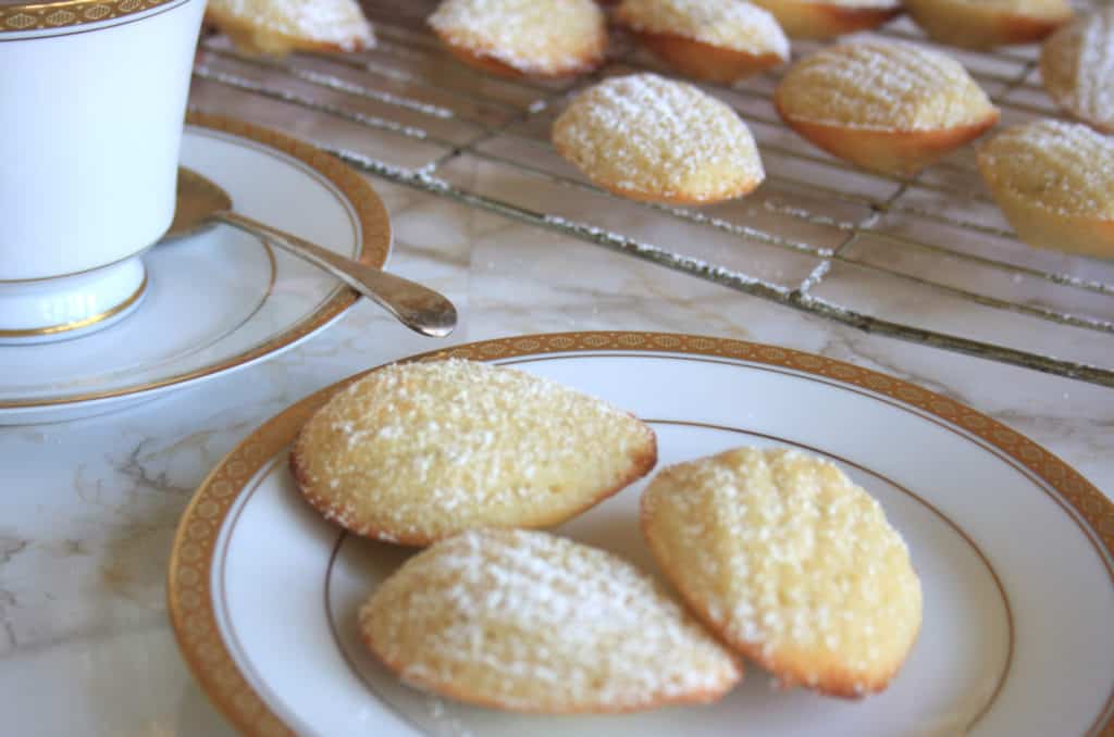 French Madeleines with Cardamom and Lime. Super light sponge cakes baked in a shell mould, dusted with icing sugar and served warm for this French classic.