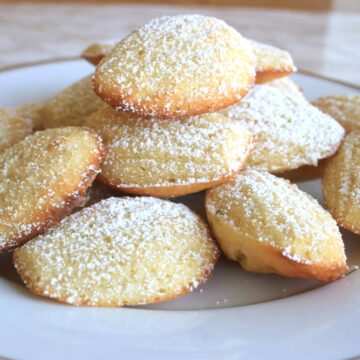 French Madeleines with Cardamom and Lime. Super light sponge cakes baked in a shell mould, dusted with icing sugar and served warm for this French classic.