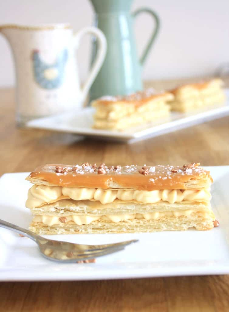 close up of a mille feuille on a plate with a fork