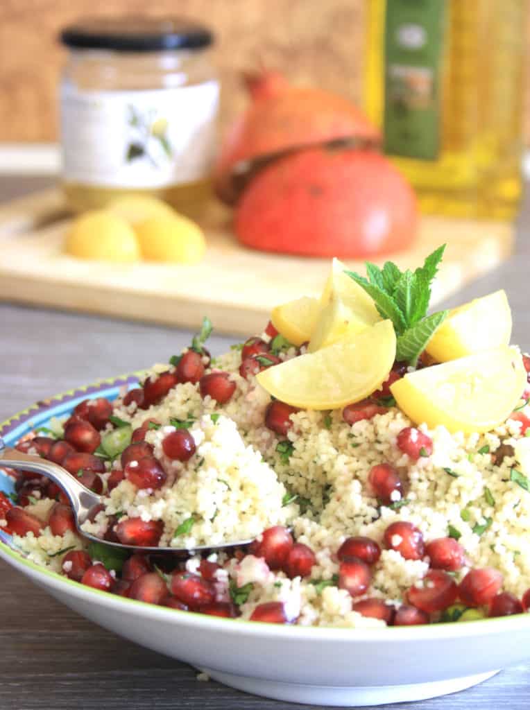 bowl of pistachio couscous with lemon garnish