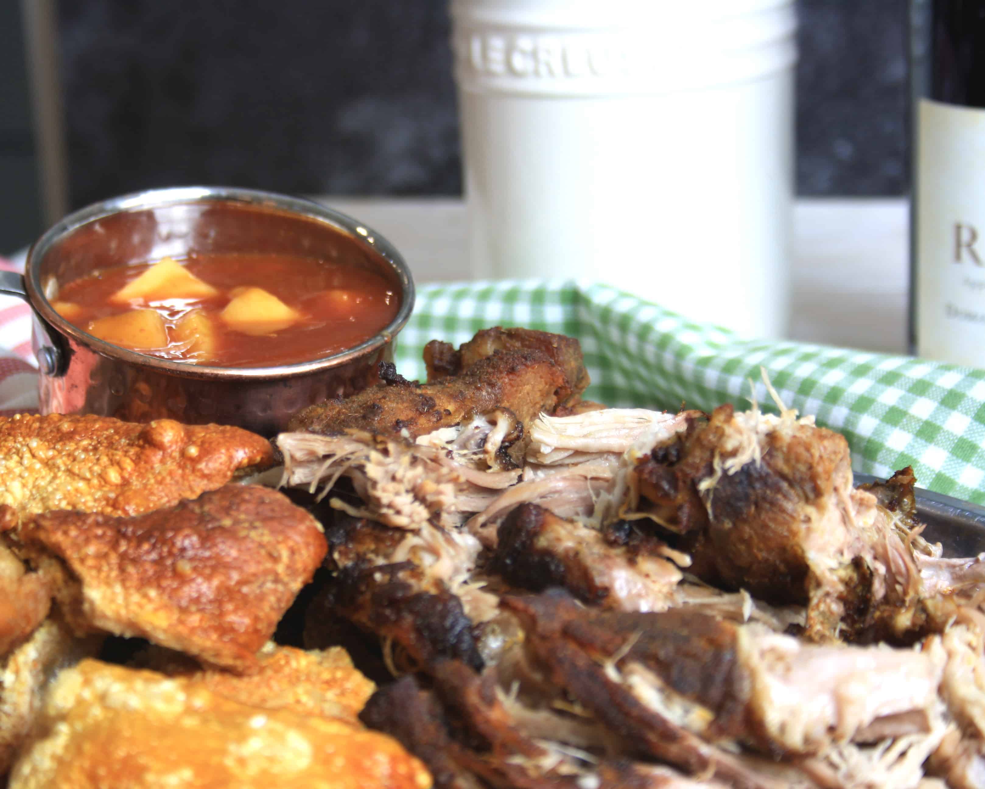 sliced pulled pork and chunks of crackling with pineapple sauce