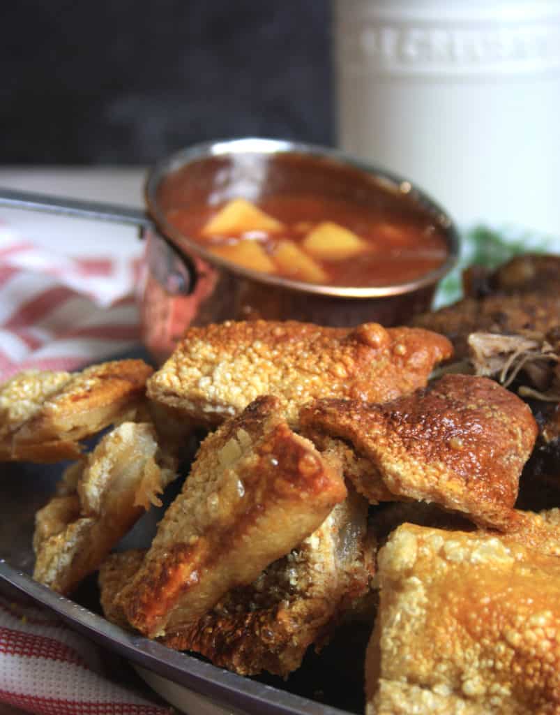  pork crackling and a pot of sauce.