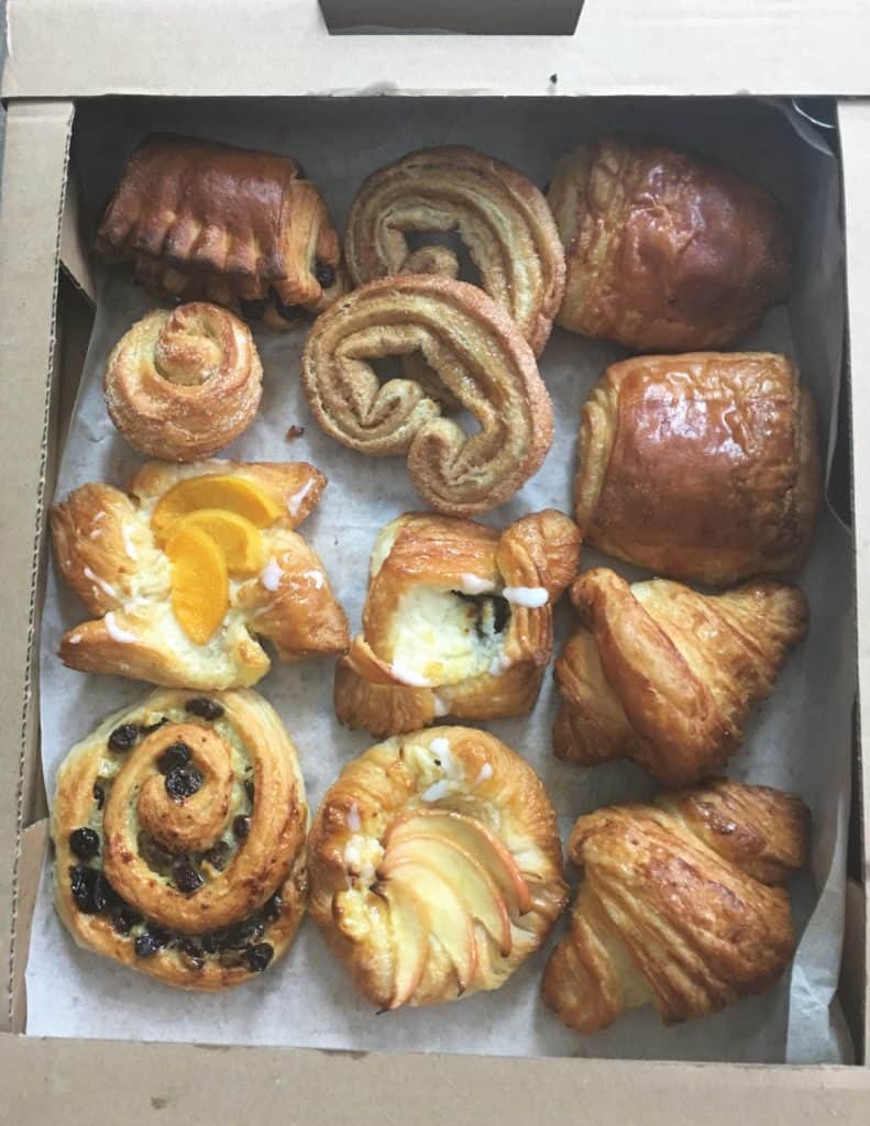 cardboard tray of assorted Danish pastries, croissants and pain au chocolat