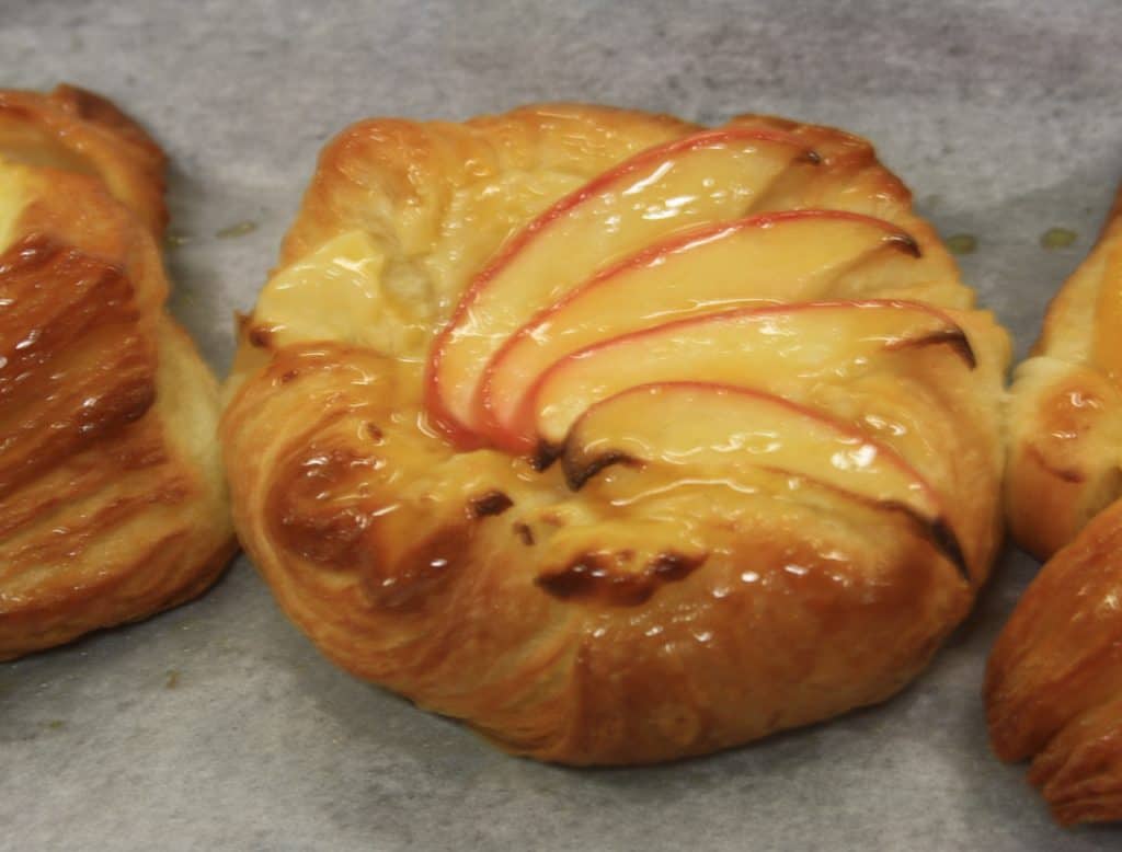 picture of danish pastry decorated with apple slices