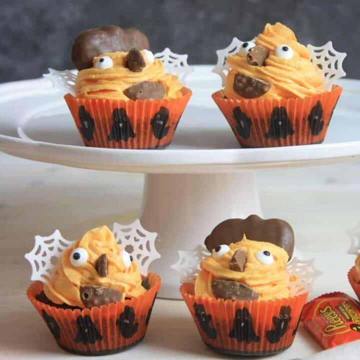 4 cupcakes decorated with Halloween decorations