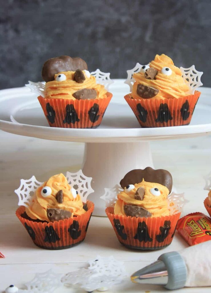 4 cupcakes decorated with Halloween decorations