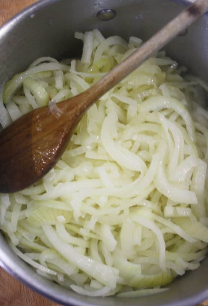 part cooked onions in a saucepan