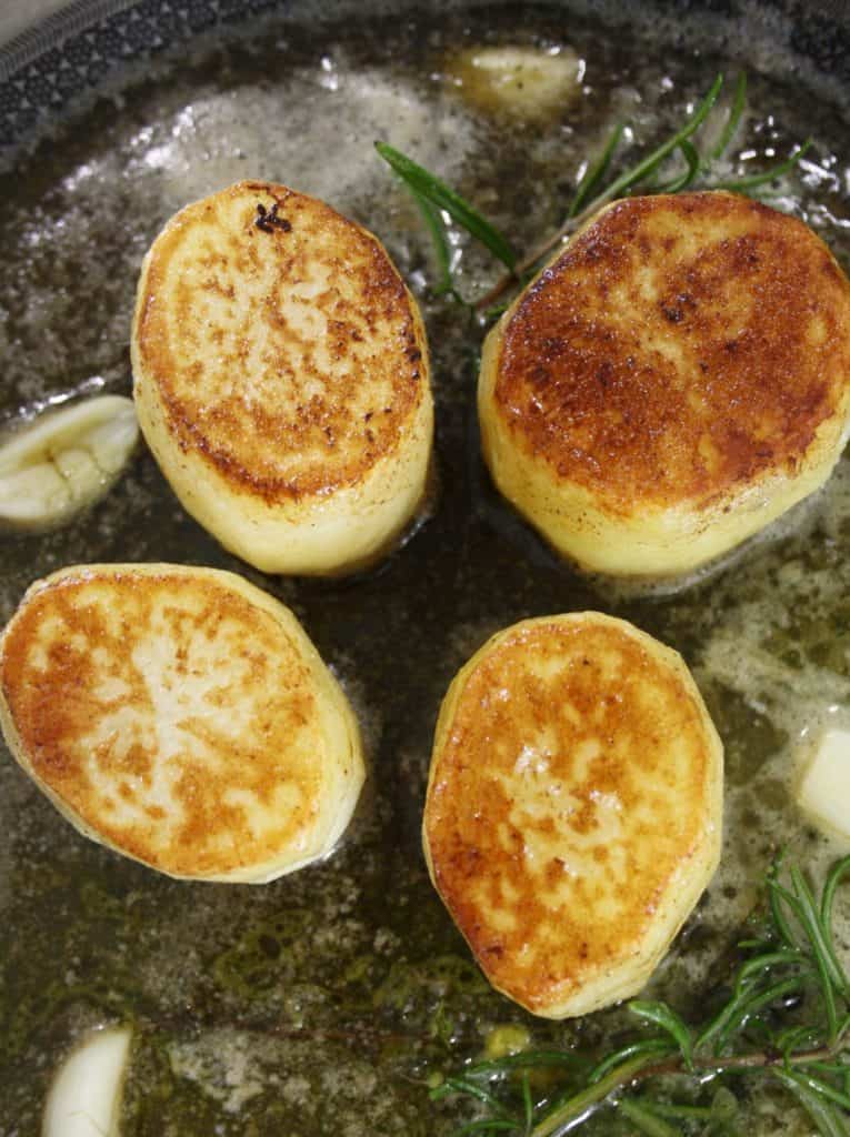 browned potatoes in a frying pan