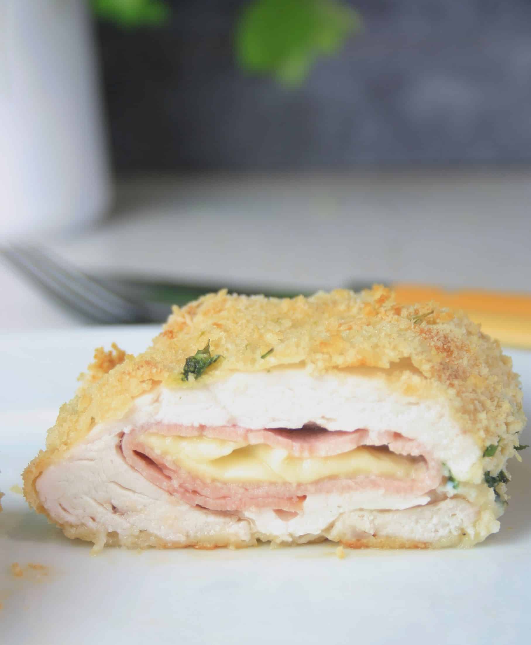 close up of cooked and cut in half chicken cordon bleu