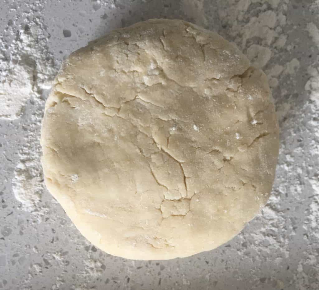 piece of homemade shortcrust pastry dough ready for rolling.