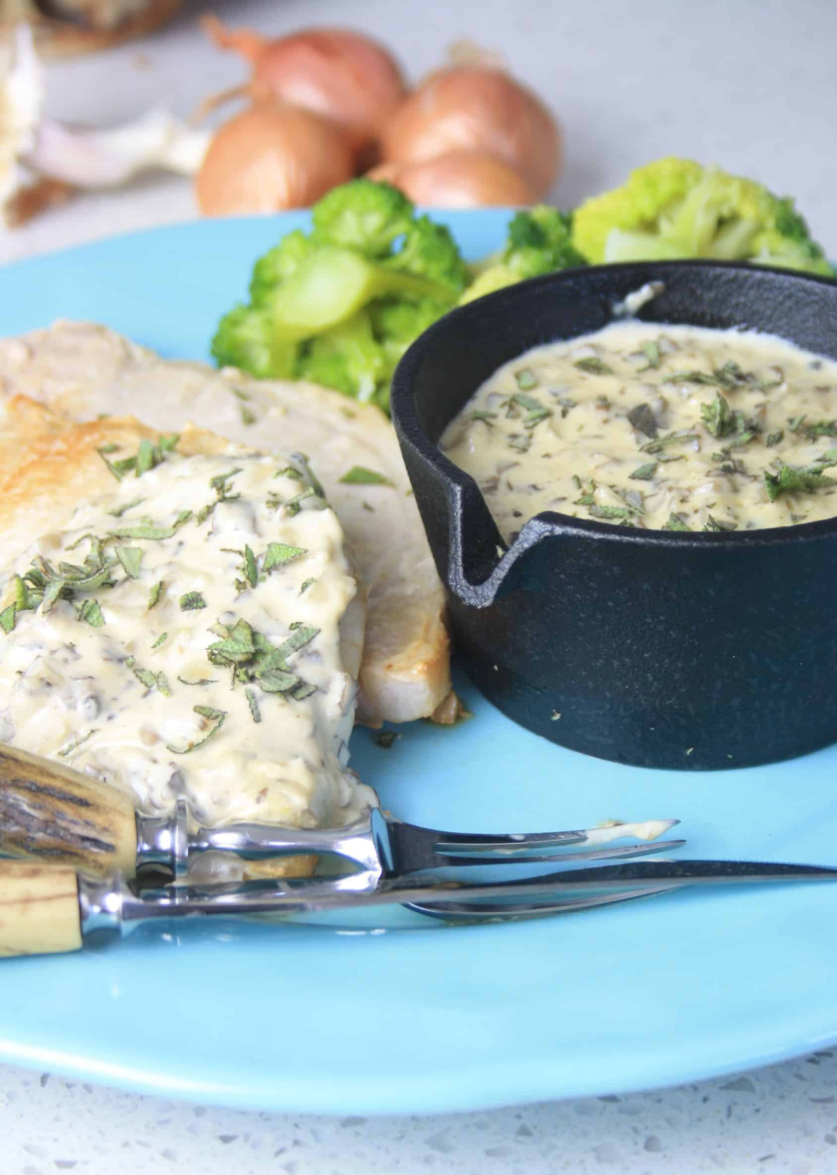 pork chops and pot of creamy sauce.