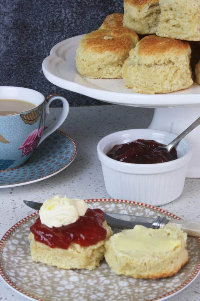 British scone with jsm, cream and cup of tea