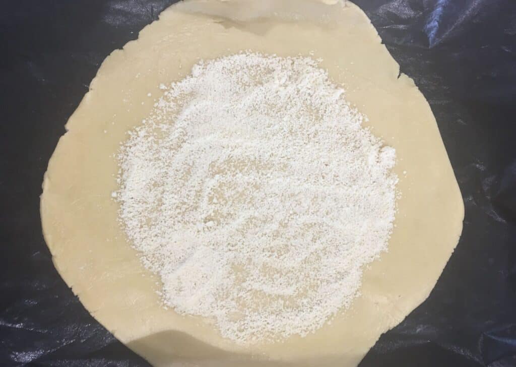pastry rolled out and sprinkled with ground almonds