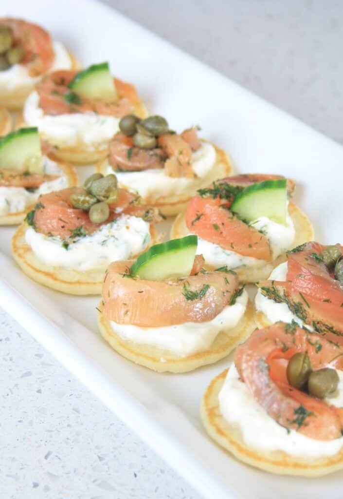 blinis with salmon gravlax and capers.