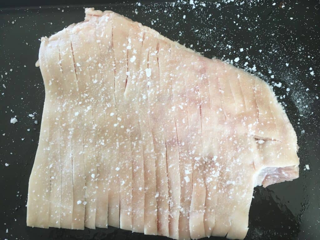 pork skin, scored and salted