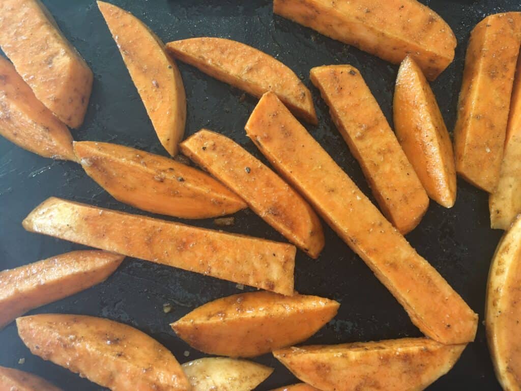 chipped sweet potatoes on a baking tray