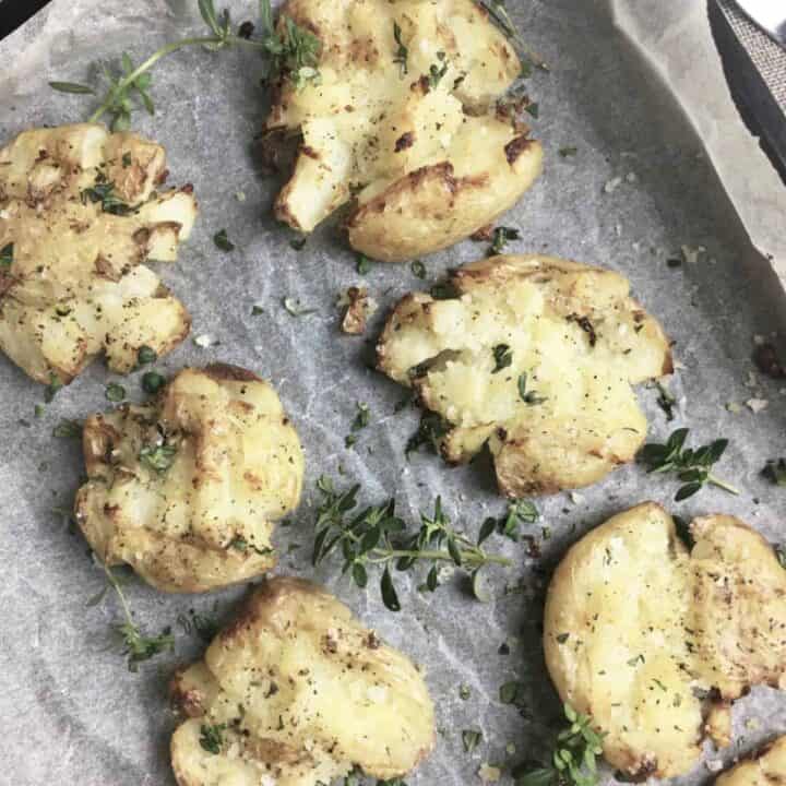 crsipy smashed potatoes on a baking tray