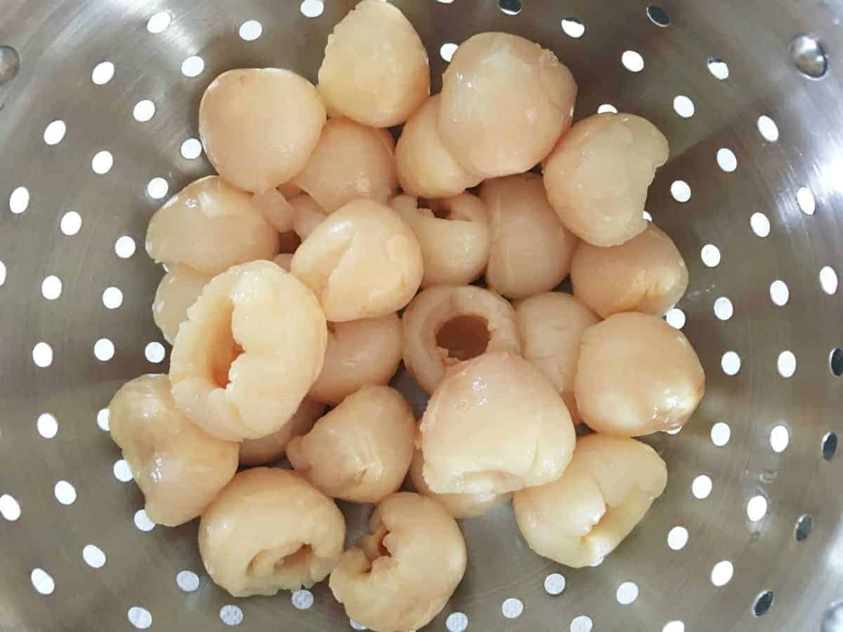 colander with lychees in it.