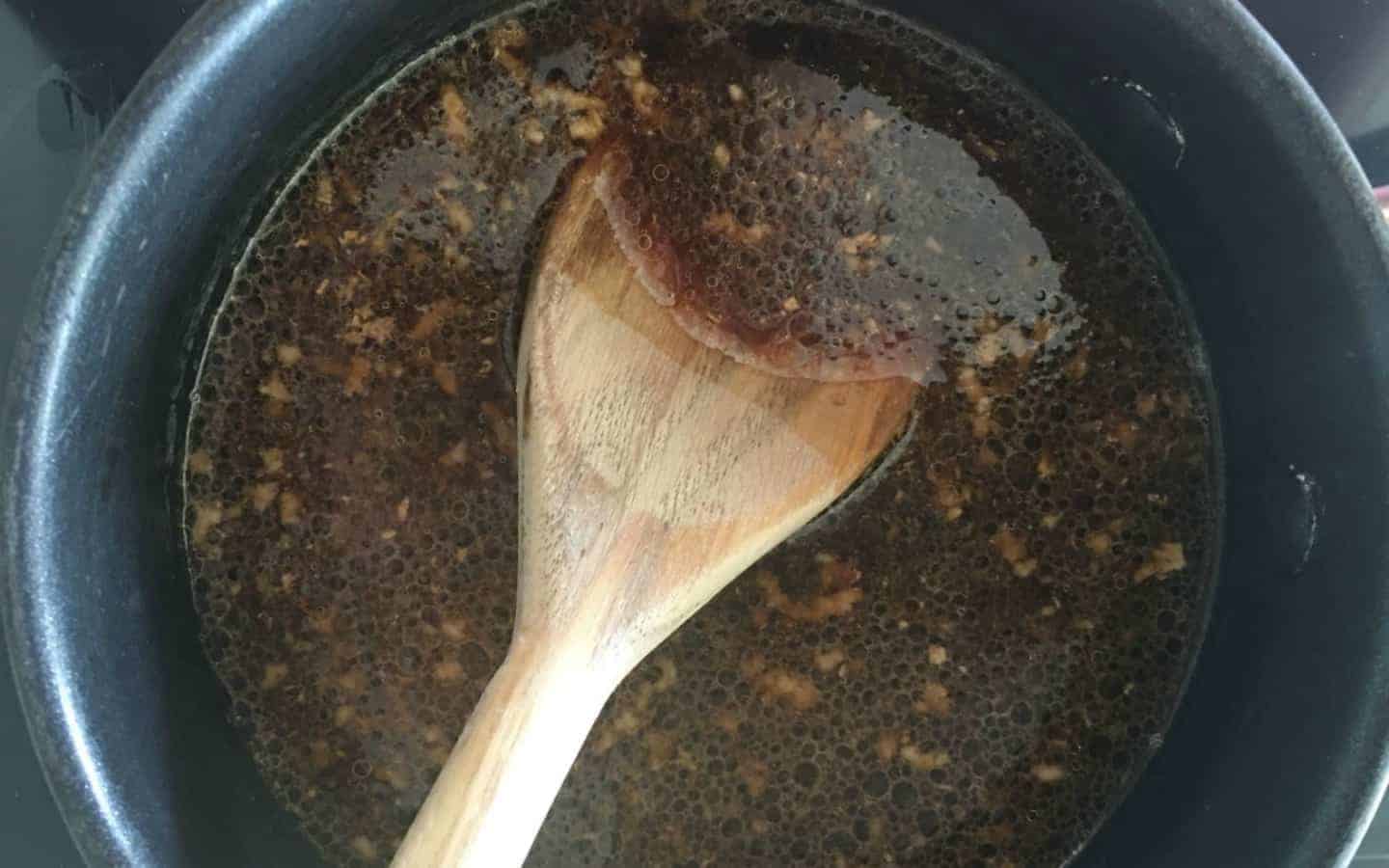 sauce in a pan with a wooden spoon