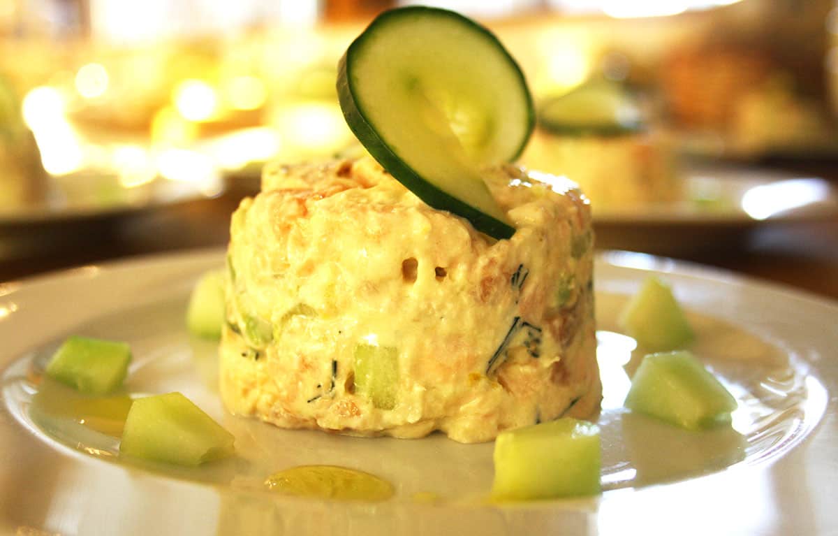 close up of salmon timbale with cucumber.