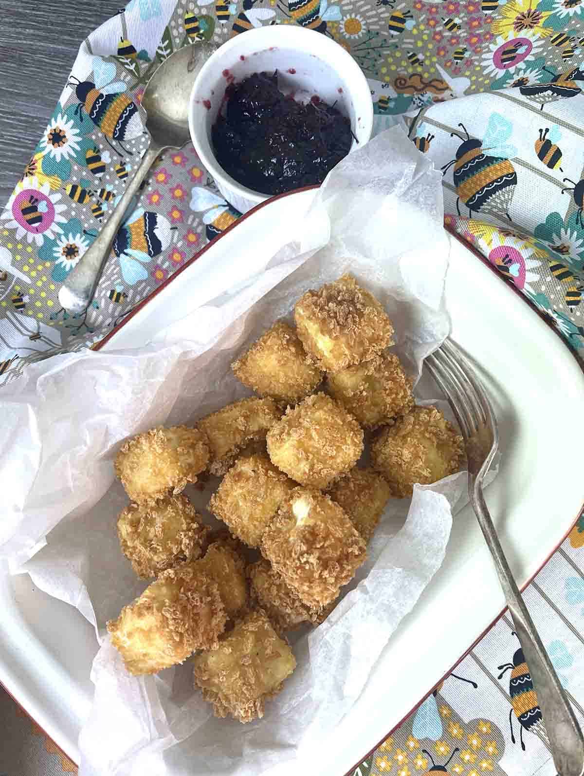 cubes of breaded bri in a dish.