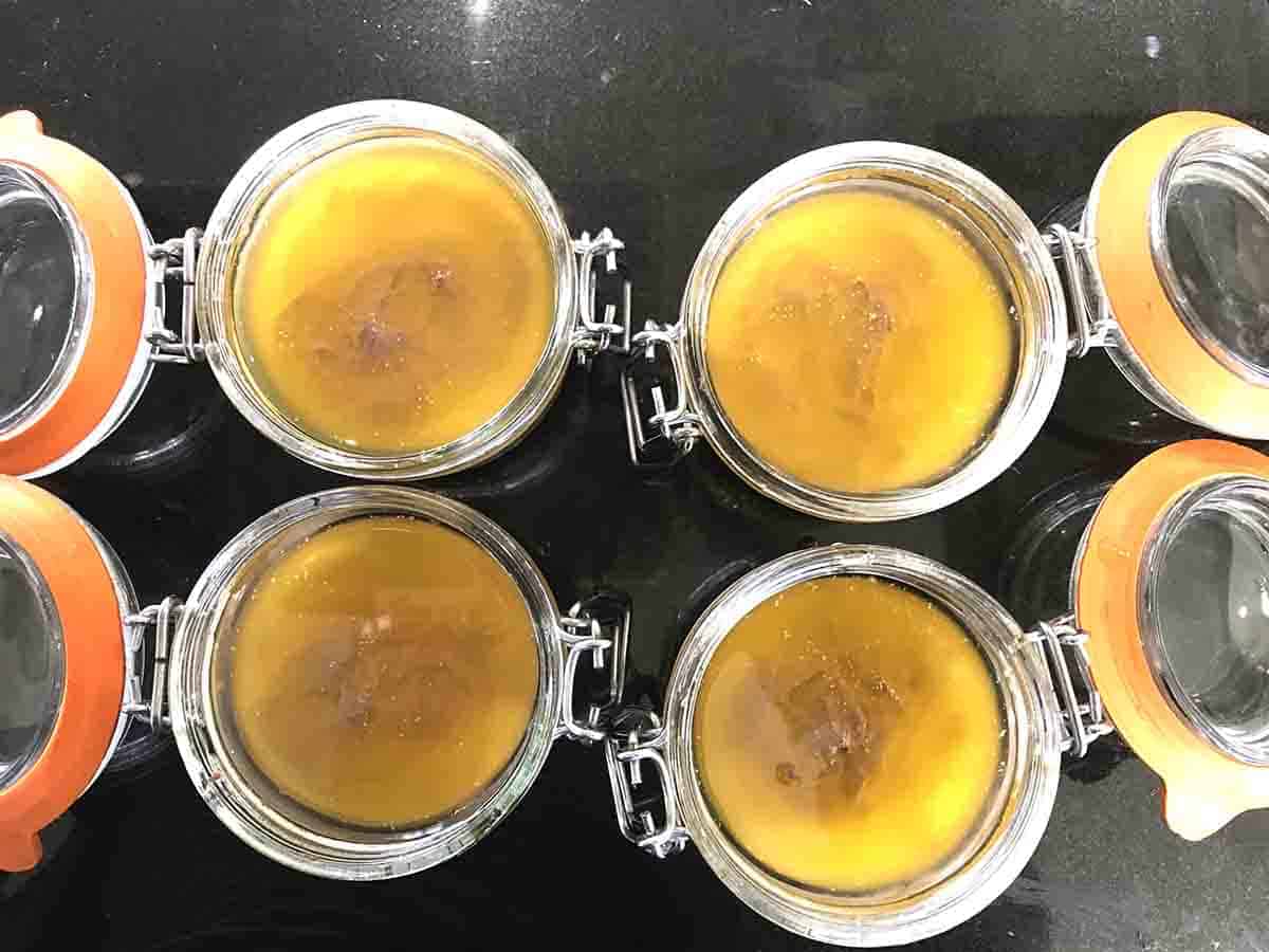 pots of parfait with clarified butter on the top.