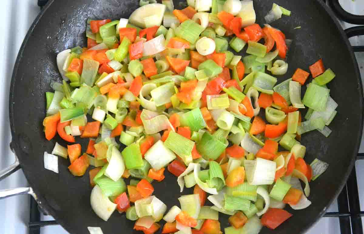 leeks, pepper sand spring onionsoftening in a frying pan.