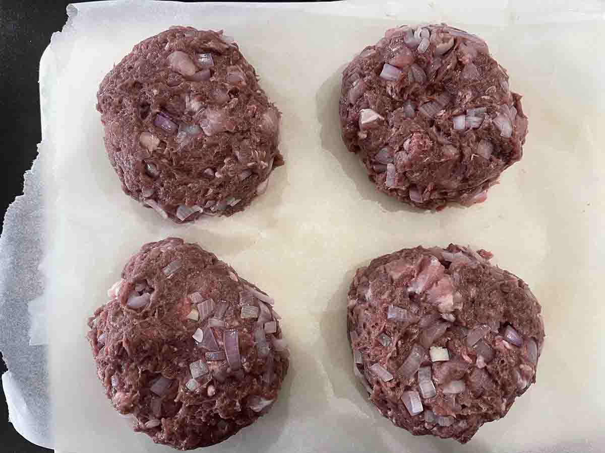 mixed mince mixture made into four burger patties.