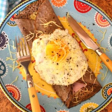 busckwheat galettes on a plate with an egg on top.