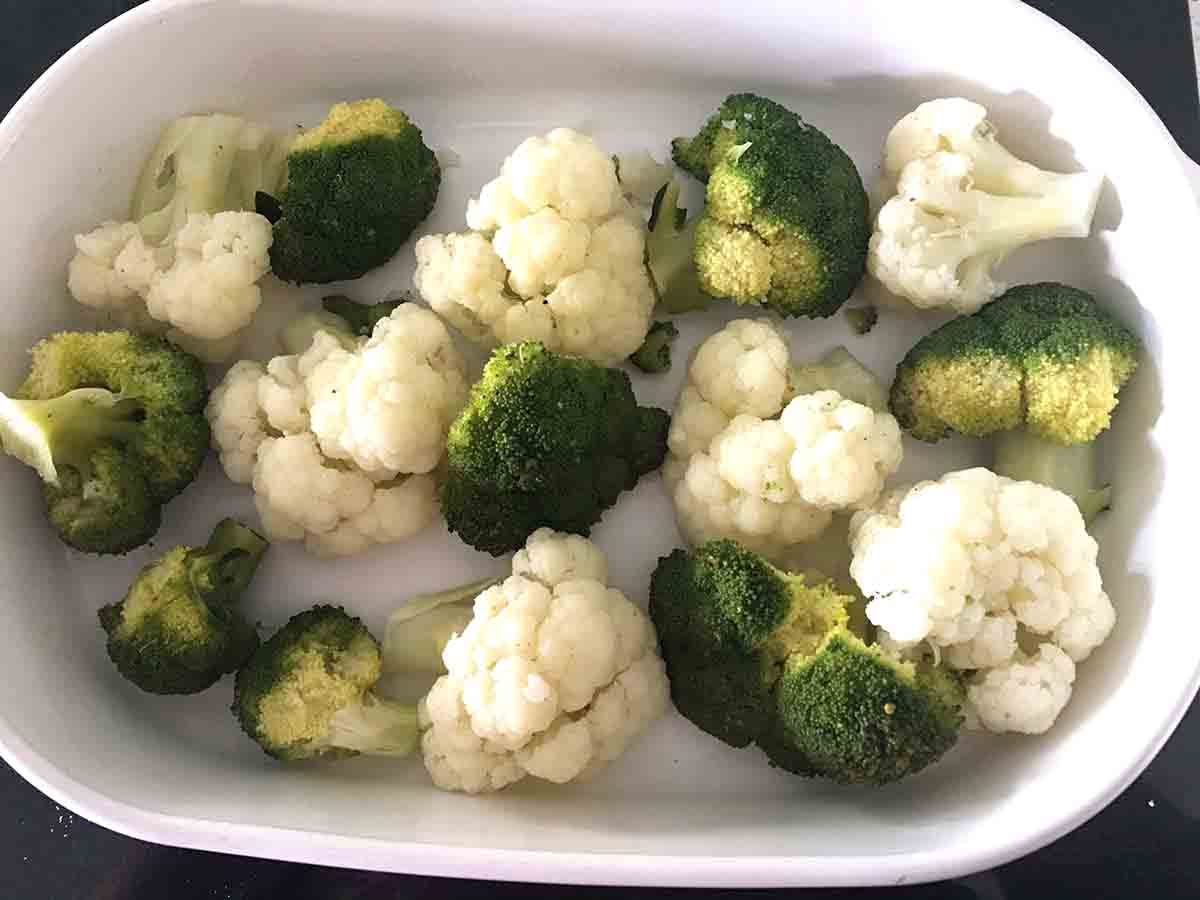 cooked broccoli and cauliflower florets in a casserole dish.