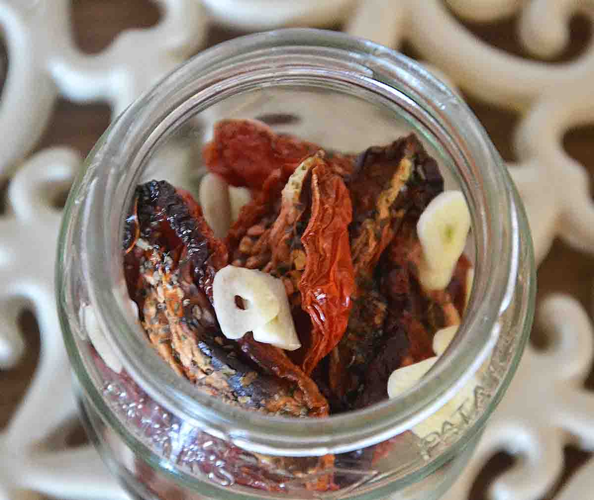 tomatoes and garlic in a glass jar.