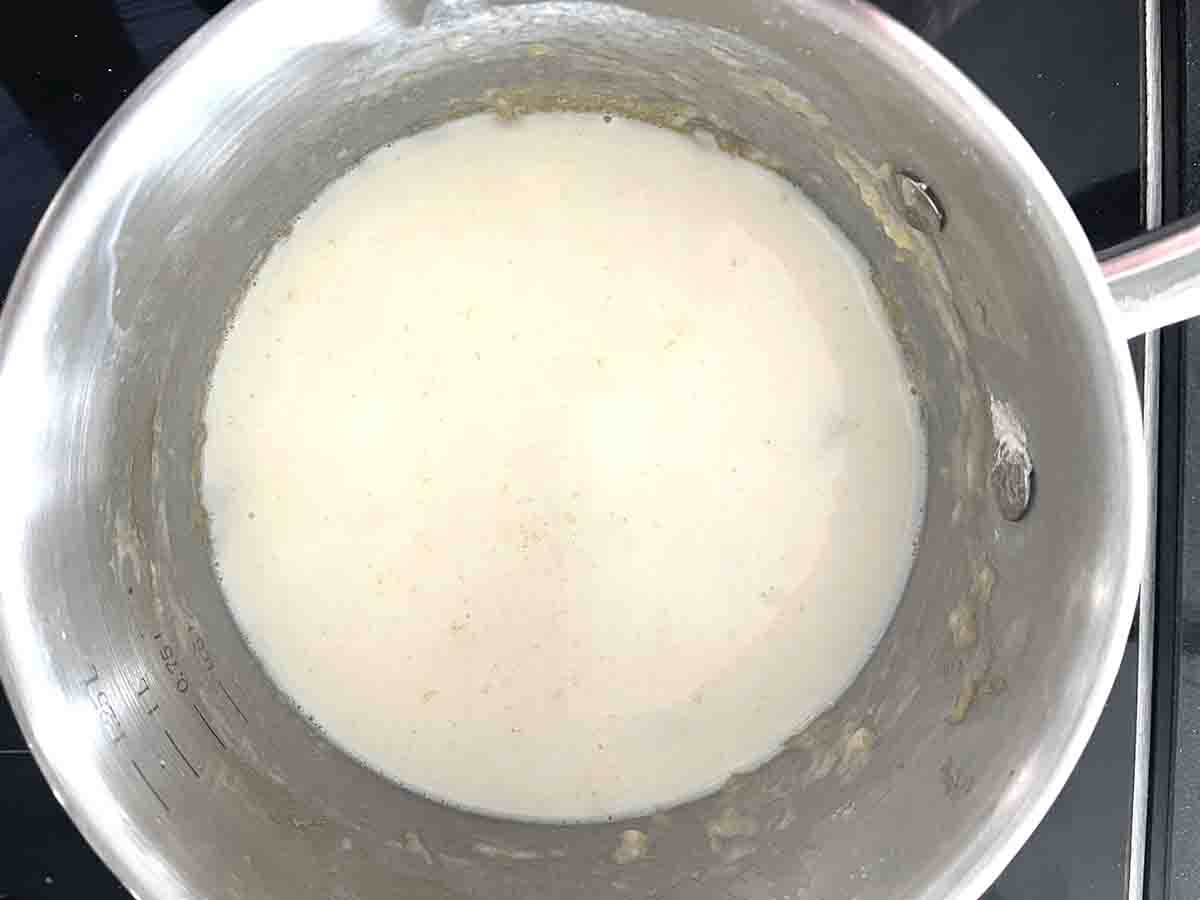 saucepan with milk added to the roux.