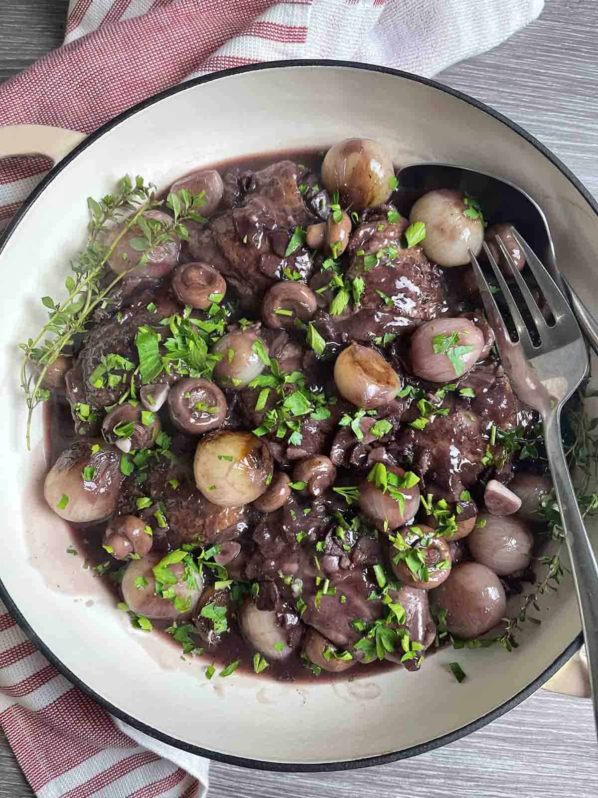 large bowl containing coq au vin.